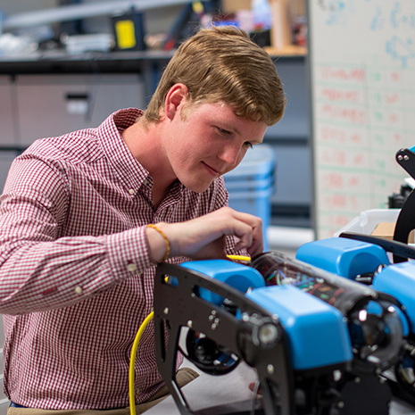 Damron works on his robot.