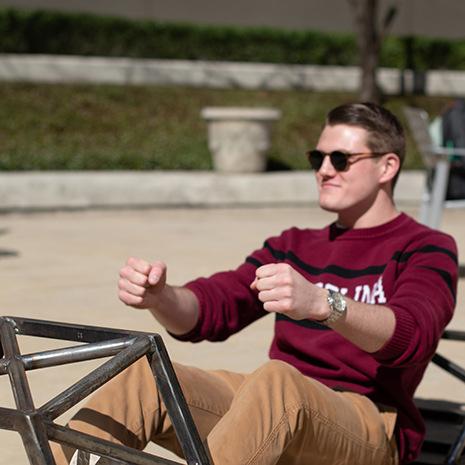 Jack Hannum sits in frame of Formula One race car.