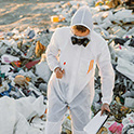 man in a cleansuit at landfill