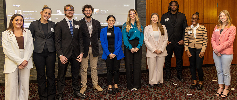 A group of students pose after the Belk Professional Dress seminar for the HRSM 301 class.