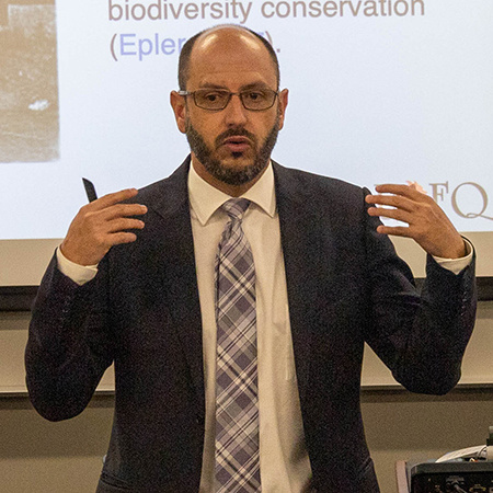 An instructor gives a lecture to a class.