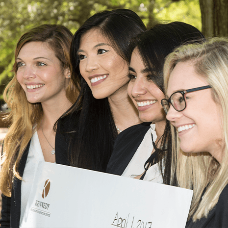 students holding an oversized check